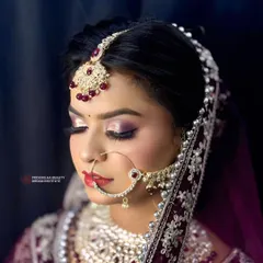 Eyes closed, the artistry shines through. This shot highlights the seamless eyeshadow blending and sharp winged liner that defines this royal bridal look.