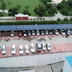 A ground-level view of the solar carport system, showing vehicles parked underneath the power-generating canopy. This is an ideal solution for institutions and commercial complexes looking to maximize the utility of their property.