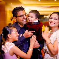 A complete family portrait filled with smiles. We love capturing the joy of the parents and siblings as they celebrate the youngest member's milestone birthday.