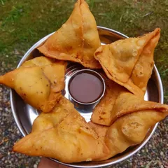 You can't go wrong with classic, hot samosas. Mine have a crispy, flaky pastry and are filled with a spiced potato and pea mixture, served with a tangy tamarind chutney for dipping.