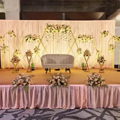This engagement stage design is modern and minimalist. We used a series of interconnected golden hexagonal frames decorated with delicate pastel flowers. The simple, clean lines create a sophisticated and stylish backdrop for the couple.