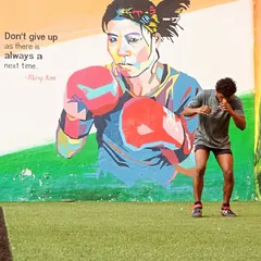 A student practices his shadowboxing form in front of our Mary Kom mural. We draw inspiration from legends to fuel our own journey.