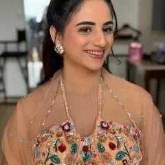 A happy smile from our 'Heer' at her haldi. The makeup is light and fresh, allowing her natural beauty to shine through.