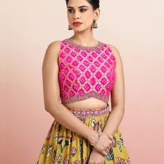 A close-up of the pink embroidered blouse, featuring a geometric Bandhani-style pattern that contrasts beautifully with the floral skirt.