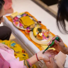 A close-up of the mehndi ritual during a Kurmai ceremony. These intimate family gatherings are where our food helps create a warm and celebratory atmosphere.