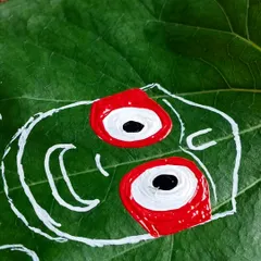 Here, I've started to fill in the base colors, applying the vibrant red to the Lord's mouth and eyes. Working on a delicate leaf requires a steady hand and careful application of paint.