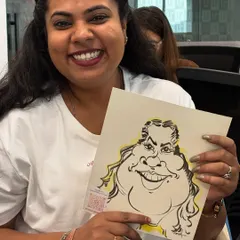 A happy employee from Urbanic with her caricature. It's always a pleasure to bring my art into the workplace.