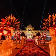 The walkway to a royal Sangeet, lined with ornate candelabras and leading towards the palace. I focus on creating an immersive journey for guests from the moment they arrive.