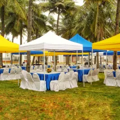 A simple and functional outdoor seating arrangement using multiple gazebos. These tents provide shade for guests and can be set up in various color combinations to match your event theme.