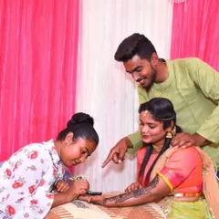 A candid moment of me applying mehndi for a client, with her family looking on. I love the festive atmosphere of a mehndi session.