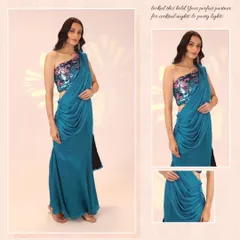 This modern drape saree in a bold blue is perfect for cocktail nights. The outfit features a one-shoulder design with a sequined floral blouse, offering a chic and contemporary take on the classic saree.