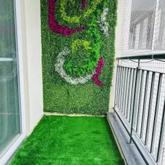 We can create custom patterns in our vertical gardens. This balcony features a unique swirl design using different colored foliage, making the green wall a true piece of art.