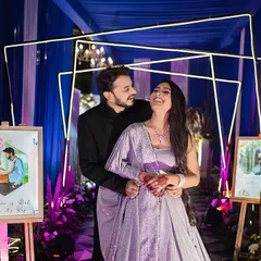 Surrounded by personalized artwork and modern decor, this couple shares a laugh during their engagement. We love capturing the joy and unique details that make your celebration truly yours.