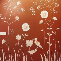 A close-up of a 3D texture mural on a rich, terracotta-colored wall in a Bangalore home. The white raised florals and a delicate crane create a beautiful contrast and a serene, nature-inspired scene.