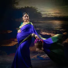 A graceful portrait of a pregnant woman in a flowing purple saree, holding a basket of flowers against a painterly backdrop.