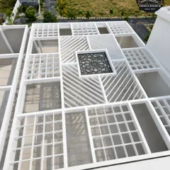 The foundation of luxury is uncompromising quality. This aerial view shows the complex geometric framework of a large-scale rooftop pergola during installation. Our precision engineering and heavy-duty steel ensure a structure that is both beautiful and built to last a lifetime.