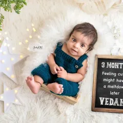 "Feeling cute, might have a meltdown later." This little chalkboard sign adds a touch of humor to this three-month milestone session, and his cheeky smile is just perfect.