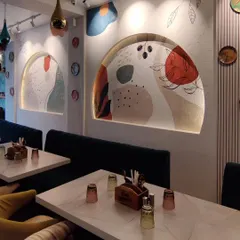 I love collaborating with businesses to bring their brand's personality to life. For this Delhi cafe, I designed a series of abstract Boho murals within arched nooks, creating a warm, trendy, and inviting atmosphere for customers.