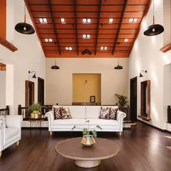 The high, vaulted ceiling with its grid of terracotta tiles and skylights is a defining feature of this home. It draws heat upward, keeping the living space cool, while casting magical light patterns that shift from morning to twilight.
