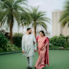 A lovely shot of a couple during their engagement shoot. The bride wears a beautiful pink saree with soft, natural makeup perfect for an outdoor setting.