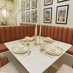 A close-up of the beautifully set dining table, with elegant tableware and candlelight, ready for a special meal.