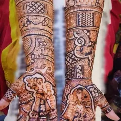 A beautiful example of combining couple portraits with traditional art. The palms feature the bride and groom, while the arms are decorated with intricate patterns and peacock figures.