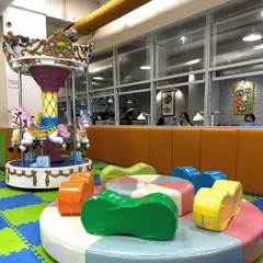 The centerpiece of our play area is this beautiful carousel, a favorite for so many children. It's surrounded by soft, colorful seating and is right next to the main play gym, making it a hub of fun.