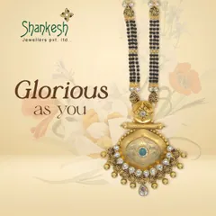 A glorious mangalsutra design featuring a modern, antique-finish pendant with stone embellishments, catering to the bride who seeks a unique yet traditional piece.