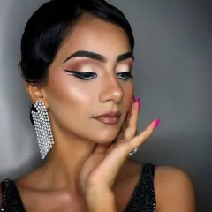A full glam look deserves a manicure to match. The hot pink nails here provide a beautiful contrast and add a layer of polish and sophistication to the entire aesthetic.