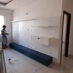 A TV unit being installed on-site. This behind-the-scenes shot shows the structure and wiring before the final decorative panels are fixed.