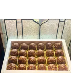 A full box of our healthy and delicious sugar-free laddoos. These are made with dates, walnuts, and other nuts, making them a perfect guilt-free indulgence.