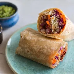 A closer look at my custom plate for EKA Whole Food Cafe, holding a delicious wrap. The subtle texture and color of the ceramic plate are designed to enhance, not overpower, the food it holds.