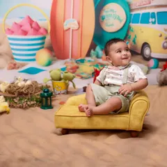 Soaking up the studio sunshine. Our beach-themed setup, complete with a surfboard, sand, and a mini-sofa, is perfect for capturing those relaxed, happy vibes, no matter the season.