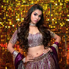 A powerful and confident pose. The makeup is bold and defined, designed to make a statement and stand out in the festive lighting of an evening event.