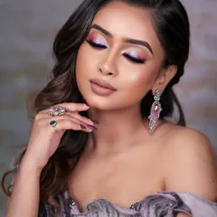 This image showcases a beautiful blend of pink and purple eyeshadows with a sharp, holographic liner. Students learn how to blend colors seamlessly and create sharp lines for a professional finish.