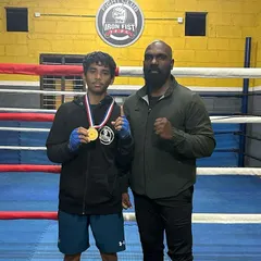 A proud moment with our "Golden Boy" Scott, showcasing his gold medal. His victory is a direct result of his discipline and the hard rounds he put in at the gym.