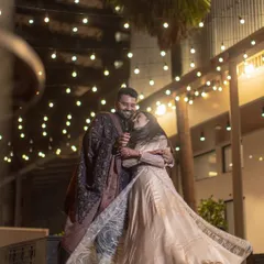 A romantic dance under a canopy of fairy lights. This night shot captures the magic and celebration of an engagement, with the bride's flowing dress adding a beautiful sense of motion.