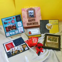 A collection of farewell gifts for a colleague. It includes custom photo frames, a personalised explosion box, and other handmade items to say goodbye in the most memorable way.