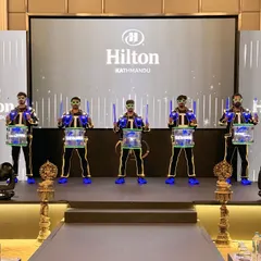 Our LED Drummers posing for a photo at the Hilton in Kathmandu. You can see the custom light-up drumsticks and the glowing translucent drums up close.