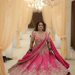 A bride deserves to feel like she is in a fairytale. This magnificent pink lehenga, with its voluminous skirt and intricate floral embroidery, creates a moment of pure magic. It’s a perfect example of how I help clients find that one show-stopping piece for their big day.