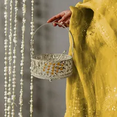 This enamel peacock basket is perfect for wedding favors or festive giveaways. Here, it's held to showcase its delicate handle and the beautiful contrast of the enamel work against the silver plating.