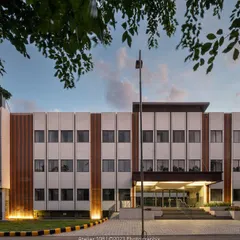 The front elevation of Jindal Public School, framed by trees. Our goal was to create a space that fosters holistic development through thoughtful design, nurturing creativity and a sense of community for hundreds of children in rural Bangalore.