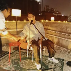 Sharing a laugh on stage during an intimate rooftop gig. These smaller shows allow for a lot of personal interaction with the audience and other performers.