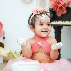Look at that cake-covered smile. Our cake smash sessions are all about letting your baby explore and have fun while we capture their adorable reactions.