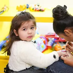 A close-up of a child getting her nails painted, a key part of our popular spa party package.