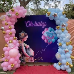 An outdoor "Oh Baby" gender reveal backdrop. The design uses a custom printed background with pink and blue balloon arches on either side, perfect for a garden or backyard celebration.