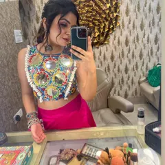 A mirror selfie capturing the details of my Navratri makeup and the vibrant mirror-work on my blouse. I love creating festive looks that are full of color and energy.