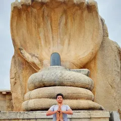 In a posture of reverence before a sacred Shiva Lingam, I connect with the origins of yoga. My workshops are steeped in this ancient tradition, viewing yoga not just as exercise, but as a profound spiritual discipline or 'sadhana' for harmonizing body, mind, and spirit.