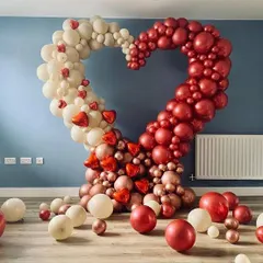 Make a grand romantic statement with this stunning, oversized heart-shaped balloon sculpture. Created with a mix of red, white, and rose gold balloons, it serves as a spectacular photo opportunity and declaration of love.