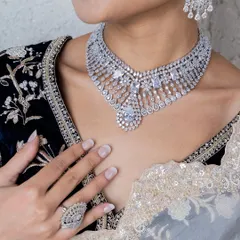 A closer look at our statement diamond necklace. The intricate design and high-quality stones create a look of pure sophistication, perfect for a reception or cocktail party.